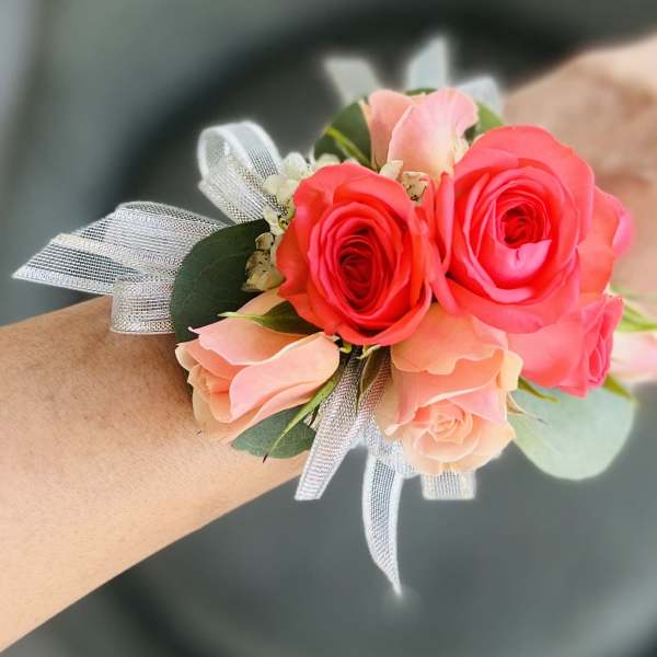 Pink and coral rose wrist corsage with silver ribbon