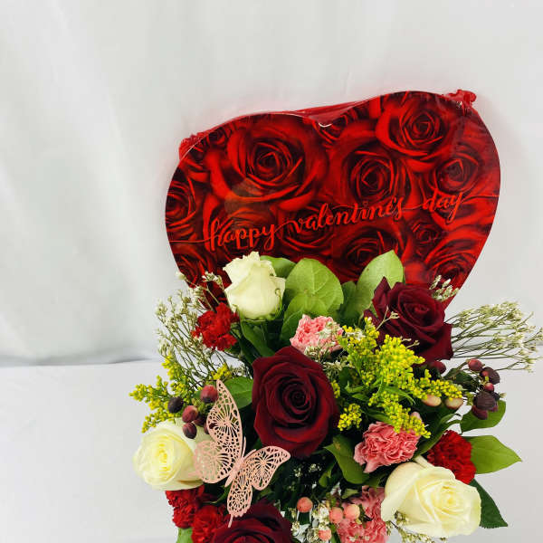 Bouquet of red and white roses with carnations and a Valentine heart backdrop