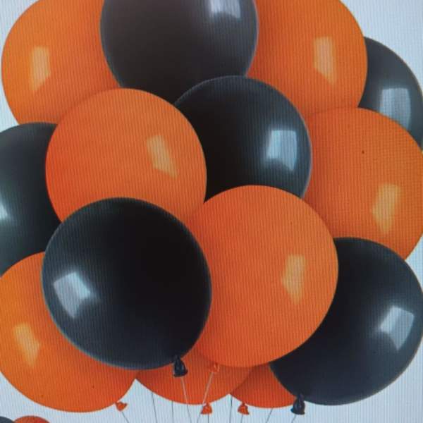 Cluster of orange and black balloons against a light background