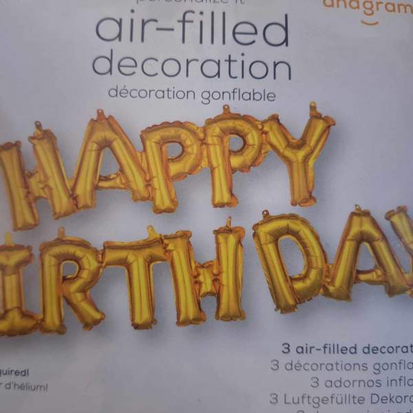 Gold birthday letter balloons on product packaging
