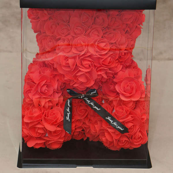Red rose teddy bear in a clear gift box with a black ribbon