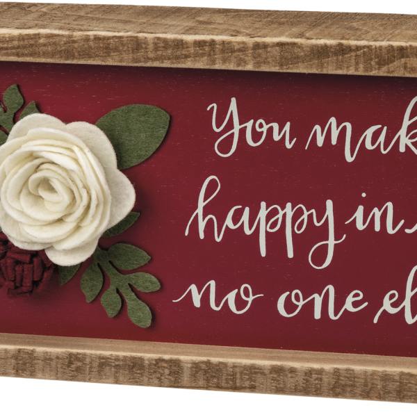Wooden sign with felt flowers and the phrase "You make me happy in a way no one else can"