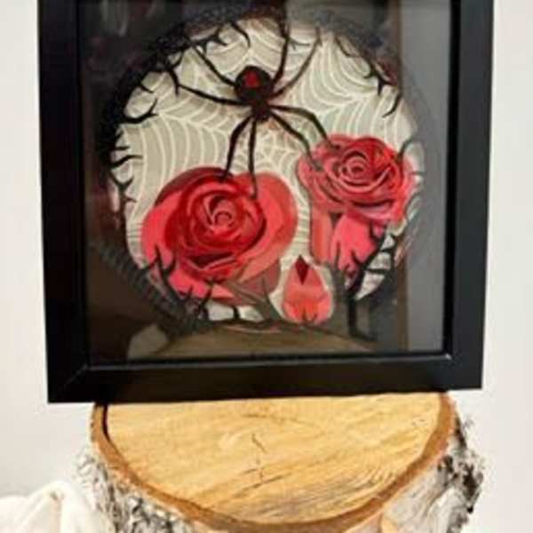 Framed spider decoration with red rose accents