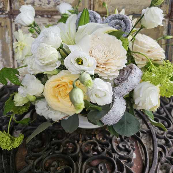 White and cream bouquet with lilies and roses in a vase