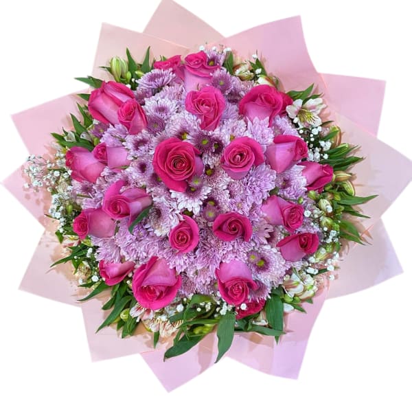 Pink rose and chrysanthemum bouquet wrapped in pale pink paper