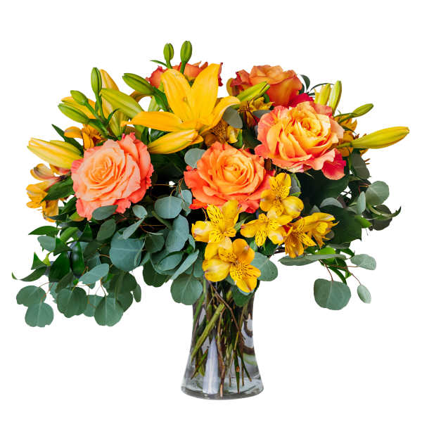 Bouquet of orange roses and yellow lilies in a clear glass vase