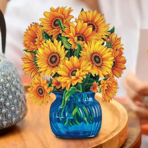 Sunflower bouquet in a blue vase on a table