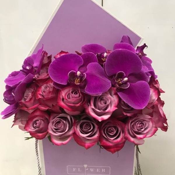 Purple orchid and pink rose bouquet in a lavender gift box