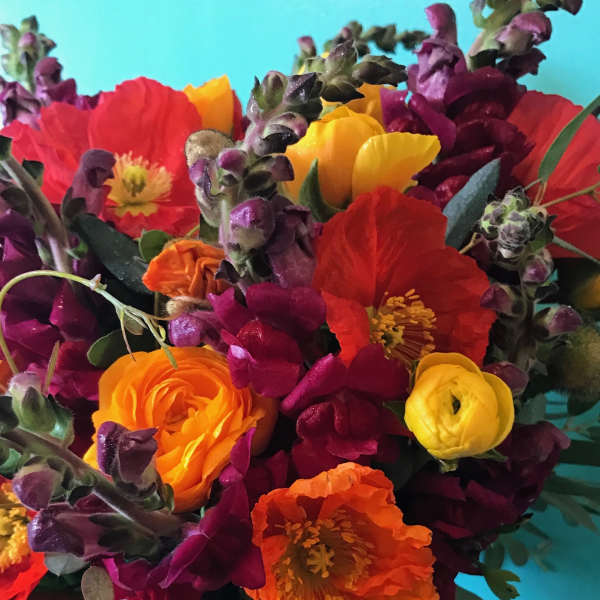 Bright mixed bouquet with red, orange, yellow, and purple flowers