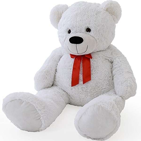 White teddy bear with a red ribbon bow