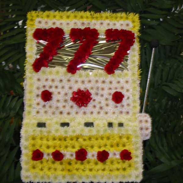 Floral tribute shaped like a bus with red and white flowers
