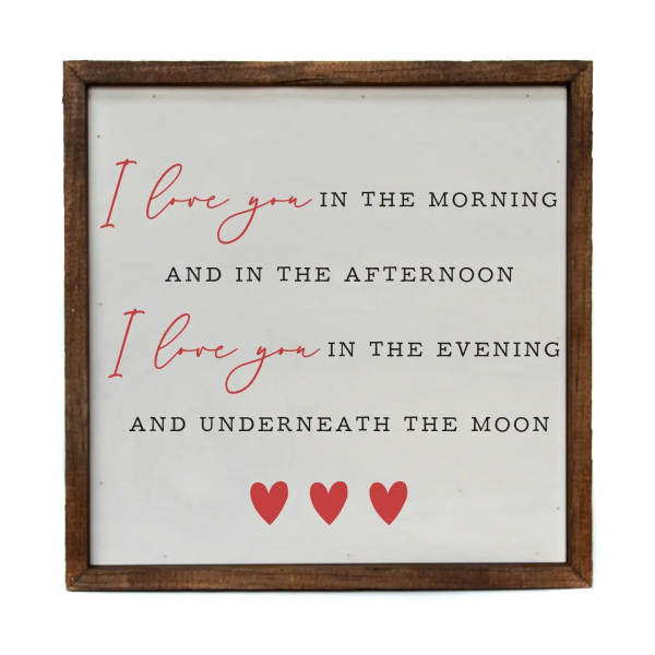 Framed sign with a love quote and three red hearts