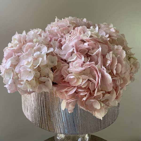 Pink hydrangea arrangement in a silver textured vase