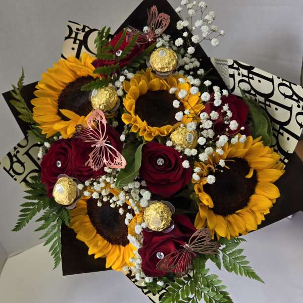 Bouquet of sunflowers and red roses with baby’s breath and chocolates