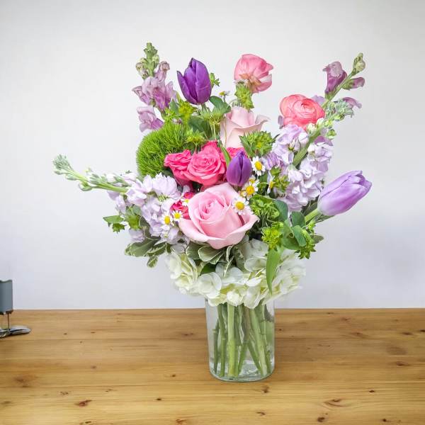 Mixed pink and purple bouquet in a clear glass vase