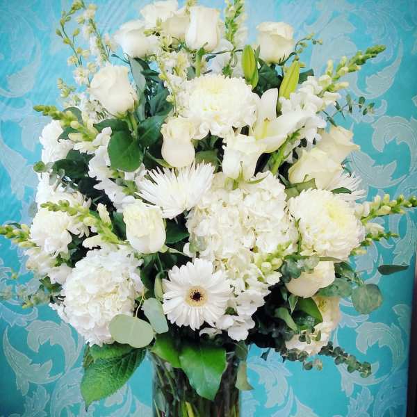 White floral arrangement in a clear glass vase