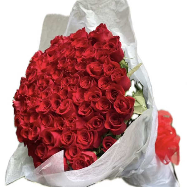 Large bouquet of red roses wrapped in white paper