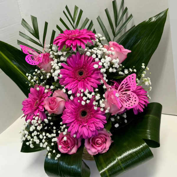 Pink gerbera and roses arranged with white baby's breath