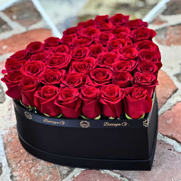 Heart-shaped box filled with red roses