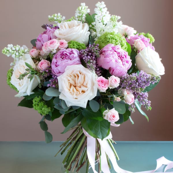 Bouquet of pink and white roses with lilac flowers