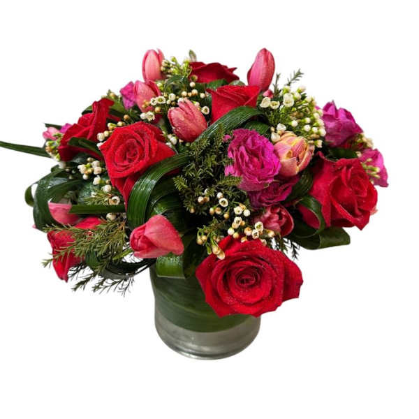 Red and pink rose bouquet in a glass vase