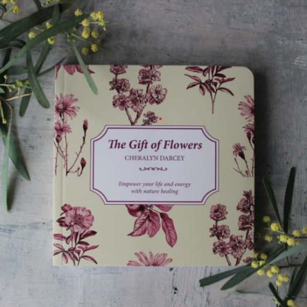 Floral-patterned book titled "The Gift of Flowers" on a gray surface