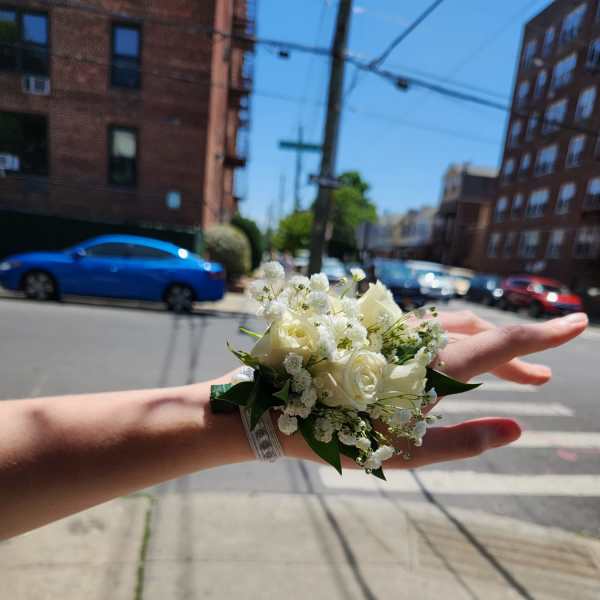 Small white rose wrist corsage with baby's breath
