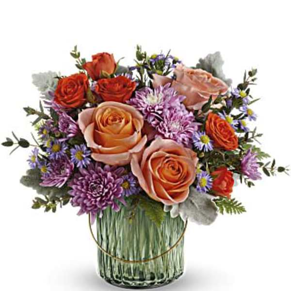 Bouquet of peach and orange roses with purple flowers in a glass vase