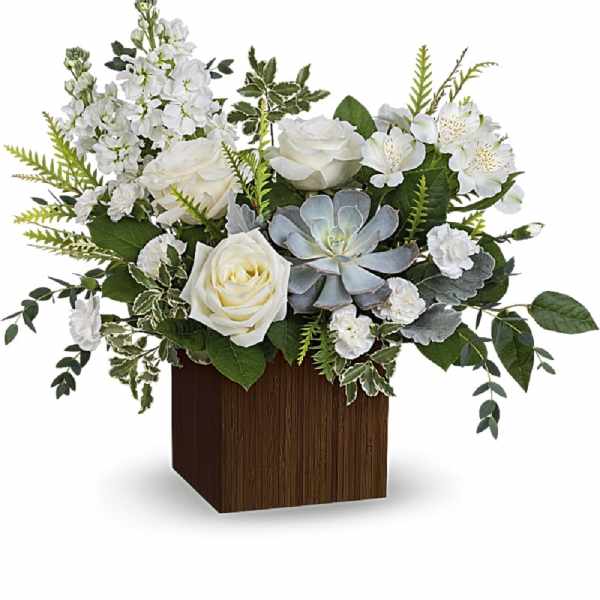 White roses and mixed white flowers in a wooden cube vase with a succulent