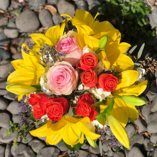 Bouquet of yellow lilies and pink and red roses