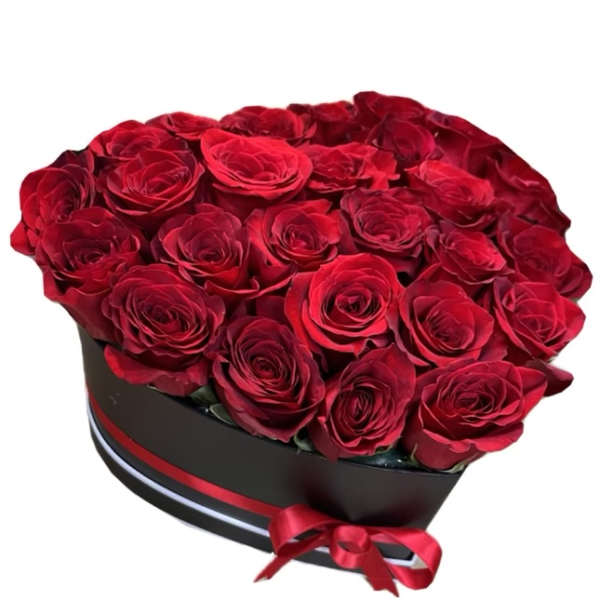 Heart-shaped box filled with red roses and a red ribbon bow