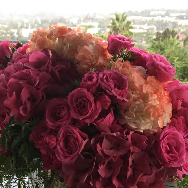 Pink roses and peach hydrangeas in a clear glass vase