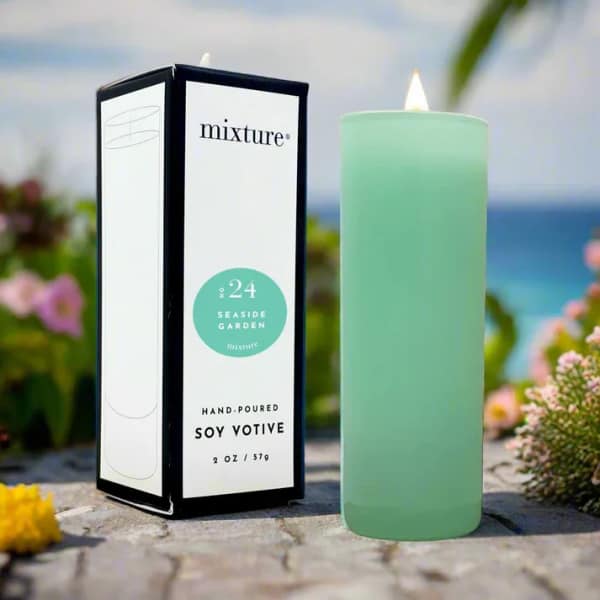 Mint green votive candle beside its box