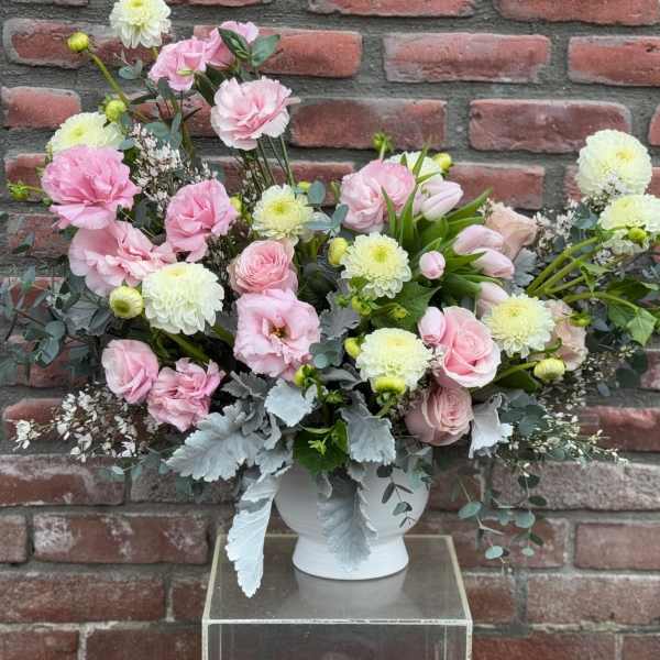 Pink and white floral arrangement in a white vase