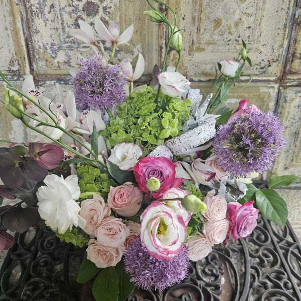 Mixed bouquet of pink and white flowers with purple blooms