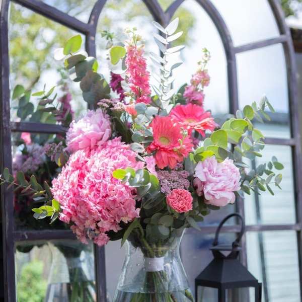 Pink mixed bouquet in a clear glass vase with eucalyptus