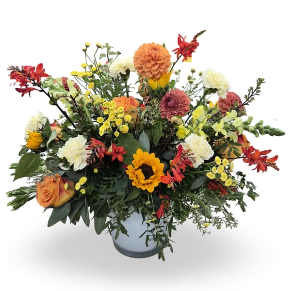 Mixed bouquet in a light blue vase with sunflowers, roses, and white blooms