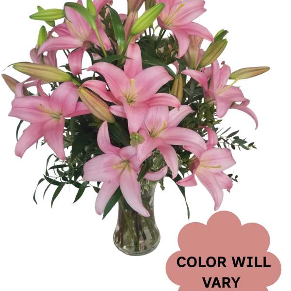 Pink lilies arranged in a clear glass vase