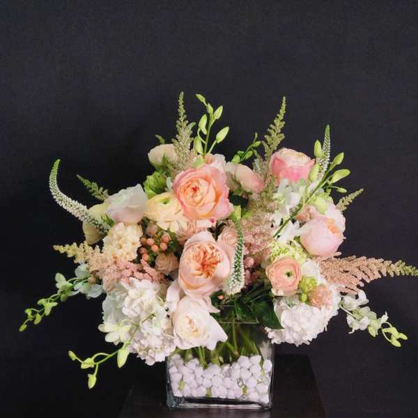 Blush and white floral arrangement in a square glass vase