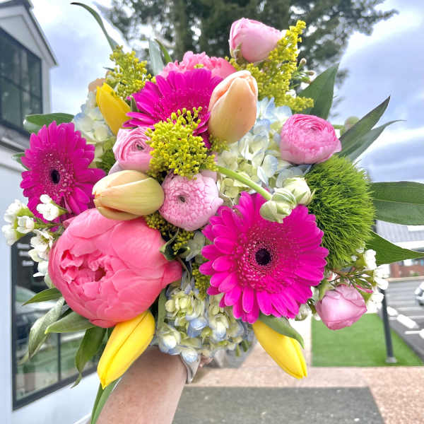 Bright bouquet of pink gerbera daisies, tulips, and peonies