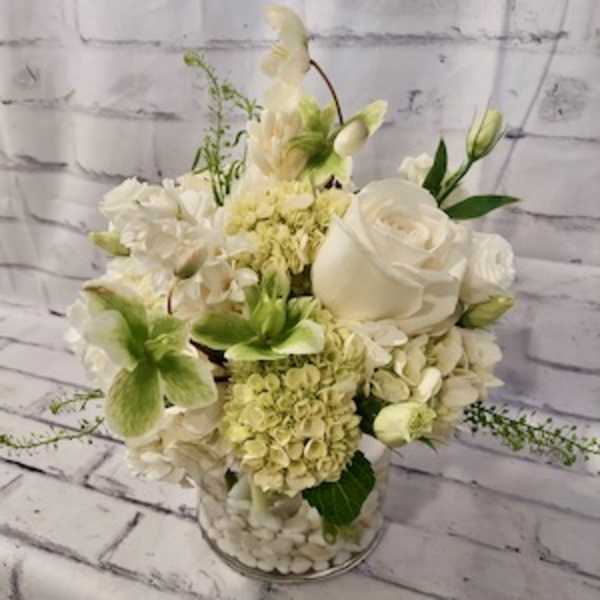 White floral arrangement in a clear glass vase