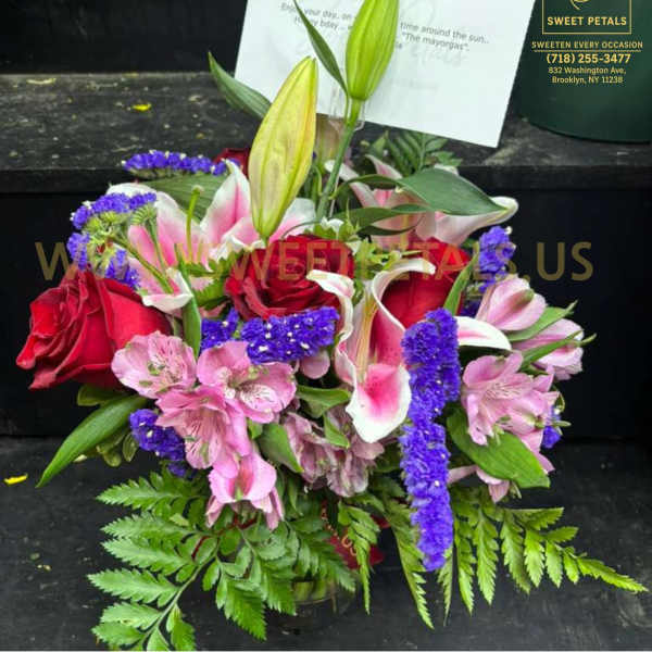 Bouquet of red roses, pink lilies, and purple filler flowers