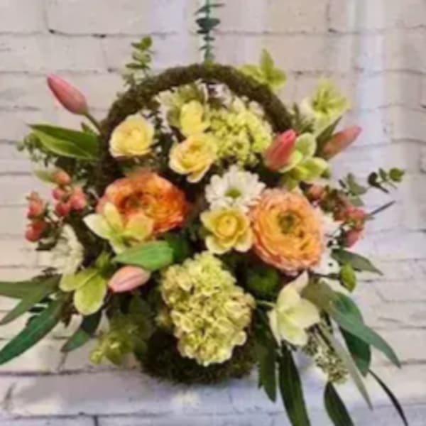 Floral wreath with mixed blooms in yellow, peach, pink, and white