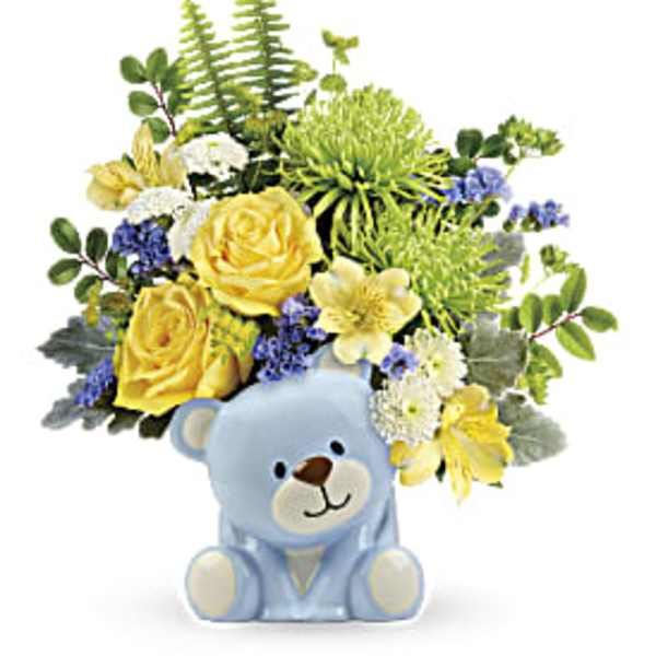 Yellow and white flower arrangement in a blue teddy bear container