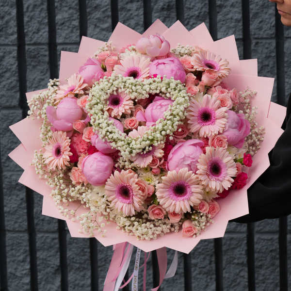 Large pink bouquet with gerbera daisies and roses wrapped in pink paper