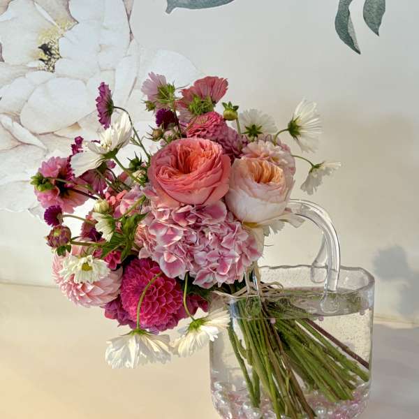 Pink and white bouquet in a clear glass vase