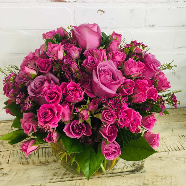 Pink and lavender rose bouquet in a glass vase