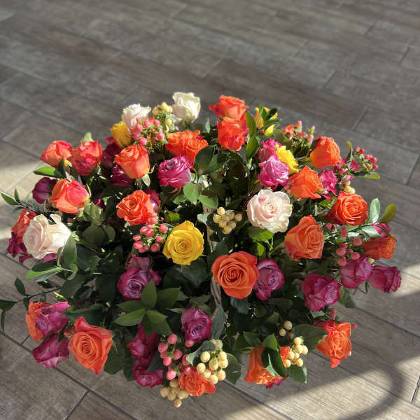 Large bouquet of multicolored roses with greenery