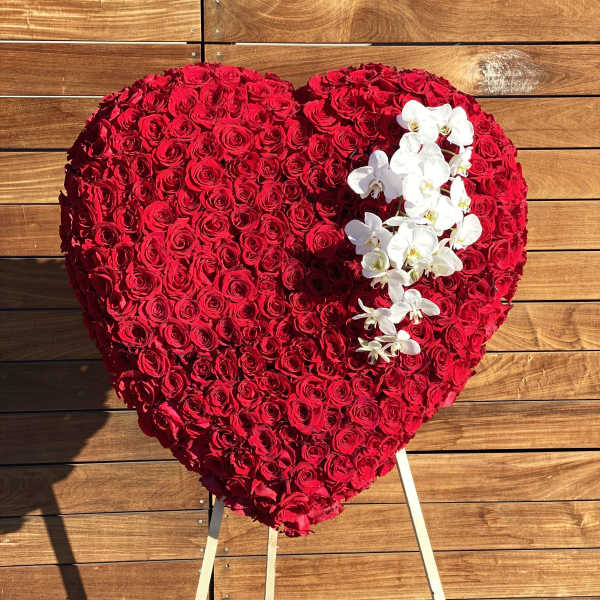 Heart-shaped red rose arrangement with white orchids