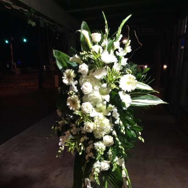 Tall white floral standing spray on an easel